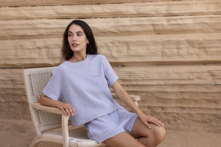 woman wearing grey pyjamas sitting on chair